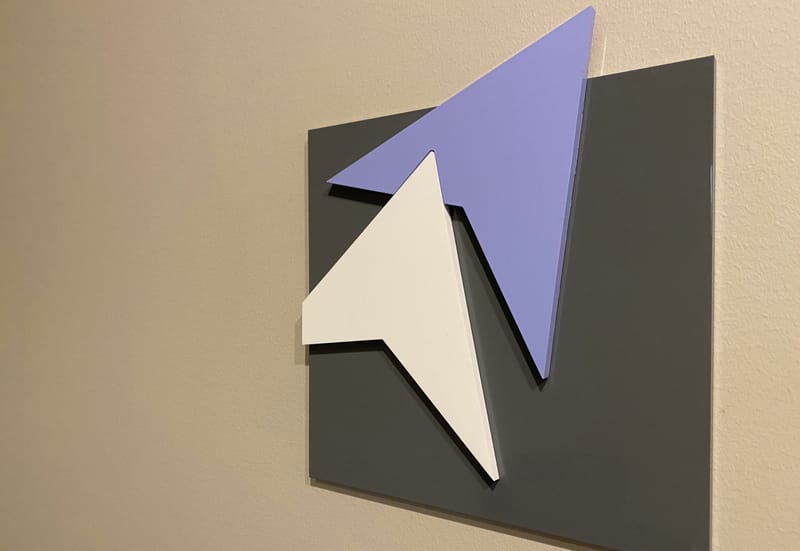 The Access Disability arrow logo as a wall sculpture in the firm's office